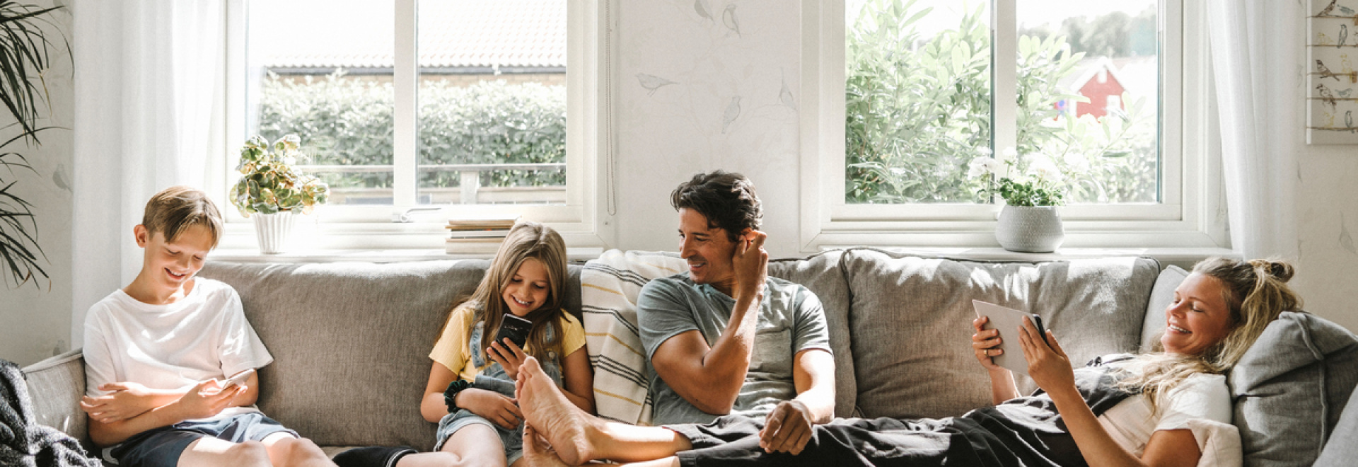 Happy family sitting on sofa in living room